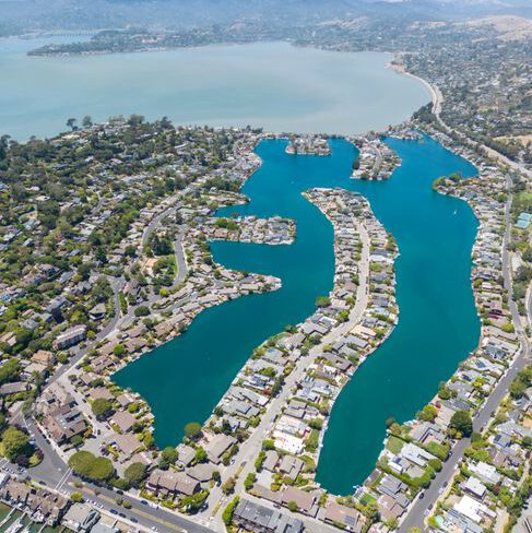 Stunning aerial photography capturing a beautiful coastal residential area by the bay.