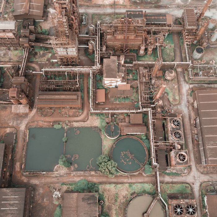 Aerial drone view of huge industrial area of wastewater treatment plant with round purification tanks